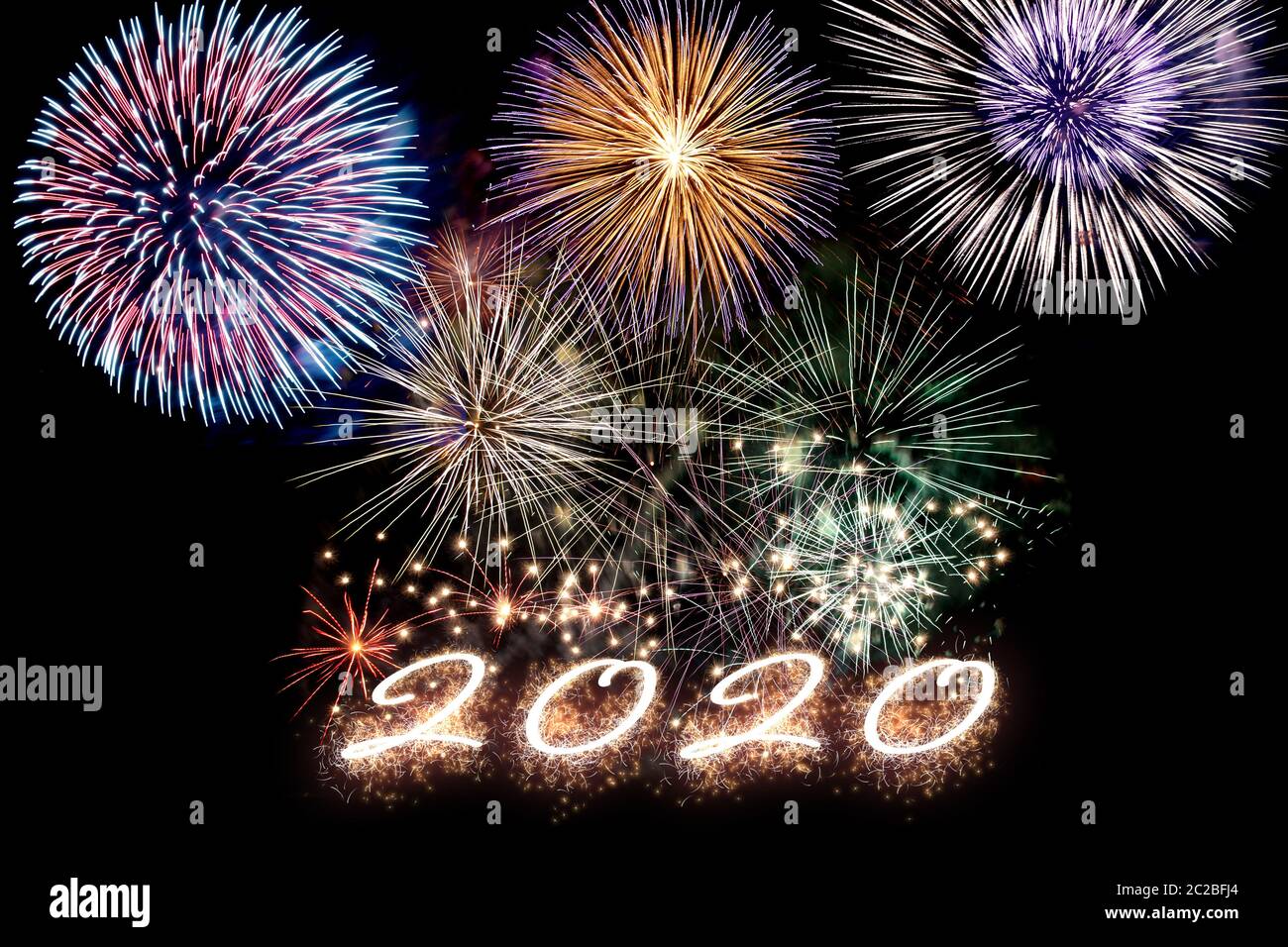Aparkling number 2020 with fireworks on dark background. Hew Year. Stock Photo