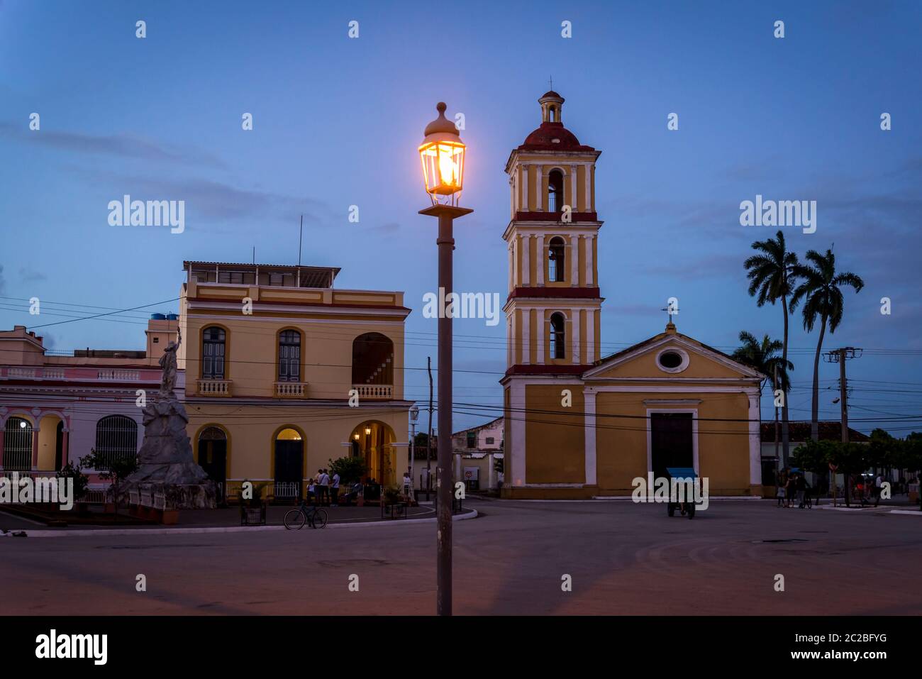 Atmospheric Central square with a church and illuminated street lamp, Remedios, Cuba Stock Photo