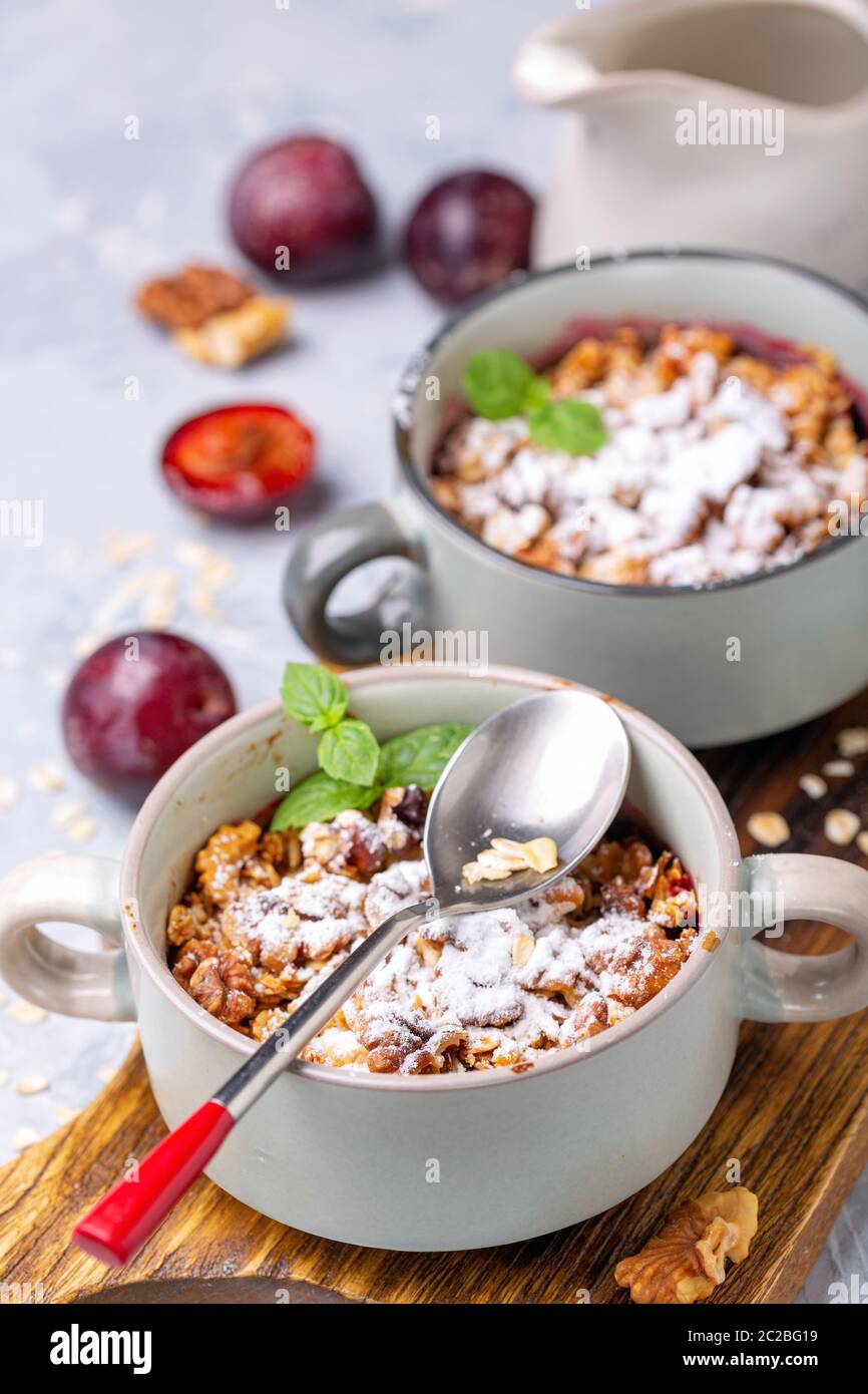 Delicious crumble of red cherry plum and oatmeal. Stock Photo