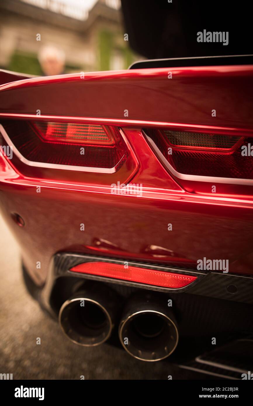 Close up vertical image of the LED tail lights and exhaust pipes of a