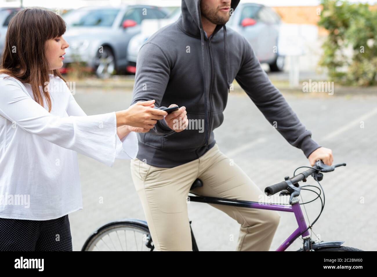 Male Thief Riding On Bicycle Snatching The Mobile Phone From Woman's ...