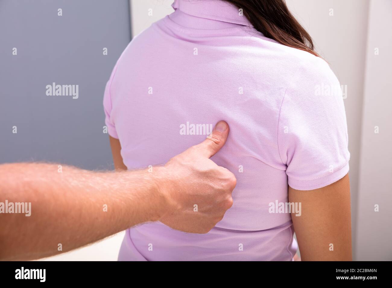 Closeup Of A Male Physiotherapist Giving Back Massage To Female