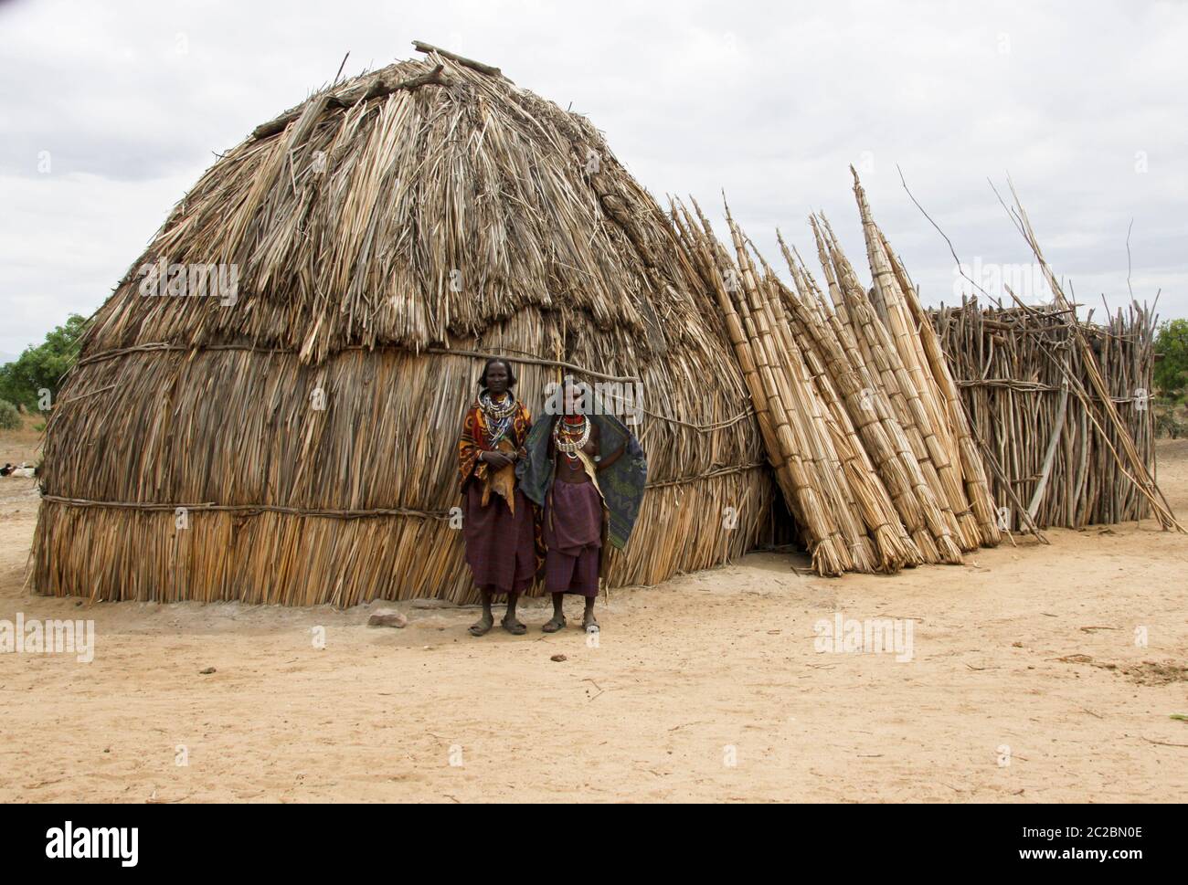 Africa, Ethiopia, Omo valley, a family of the Arbore tribe stands in front off their straw hut Stock Photo
