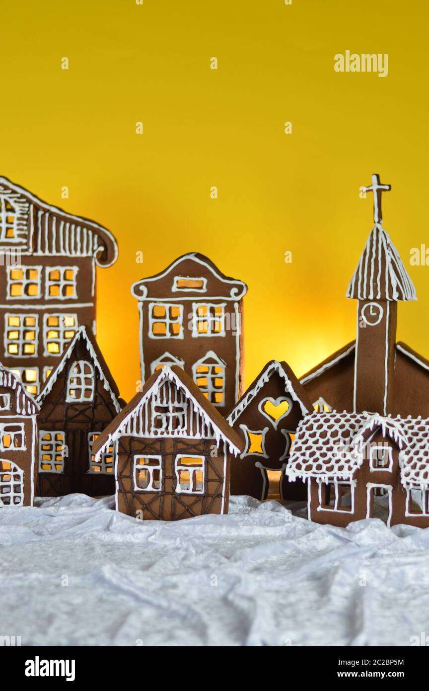 home made gingerbread village with yellow background Stock Photo