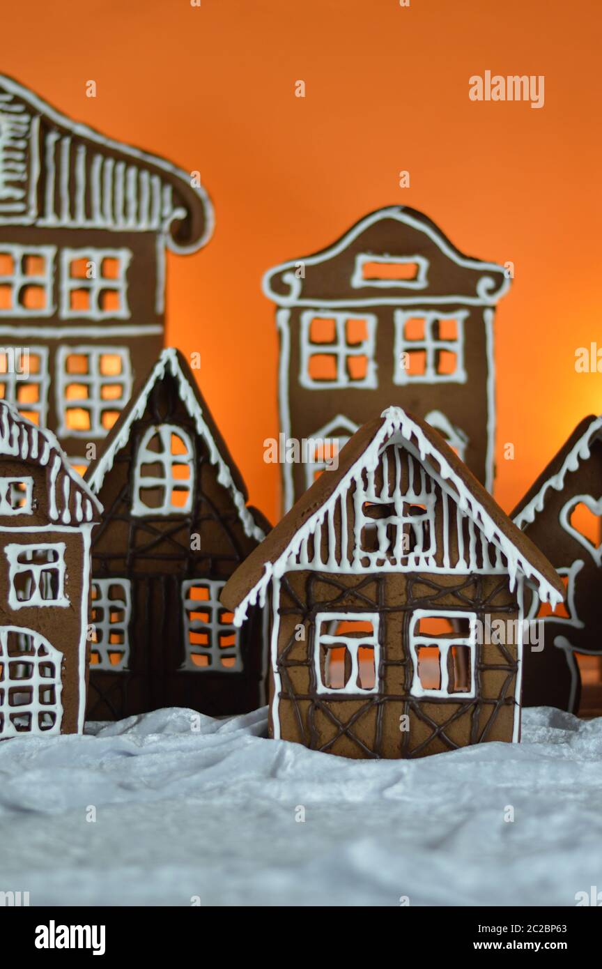 home made gingerbread village with orange background Stock Photo