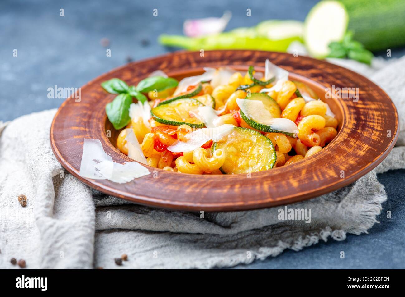 Pasta with zucchini, tomatoes and Parmesan. Stock Photo