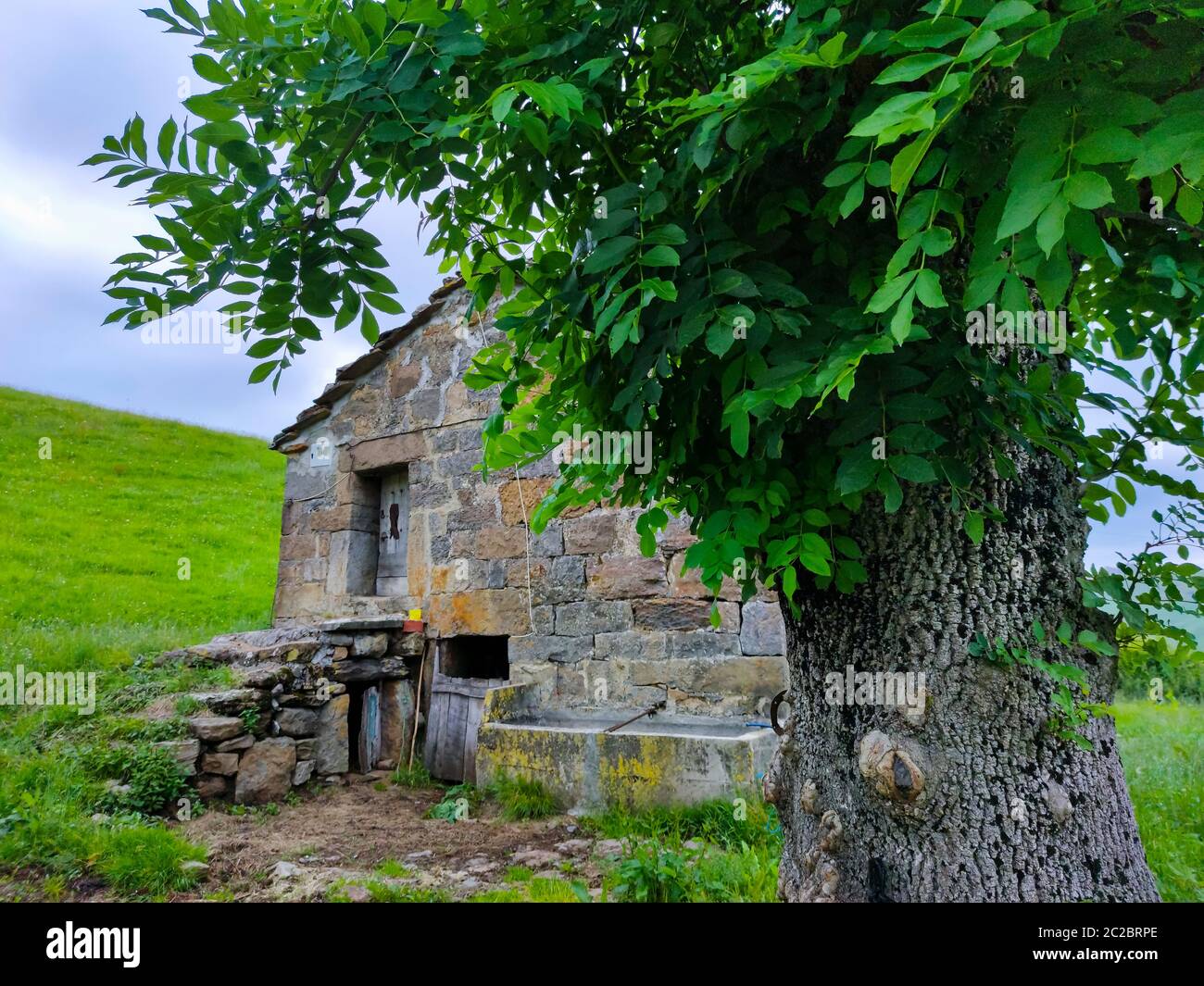 Spring landscape of pasiegas cabins and meadows in the Miera Valley in the Autonomous Community of Cantabria. Spain, Europe Stock Photo