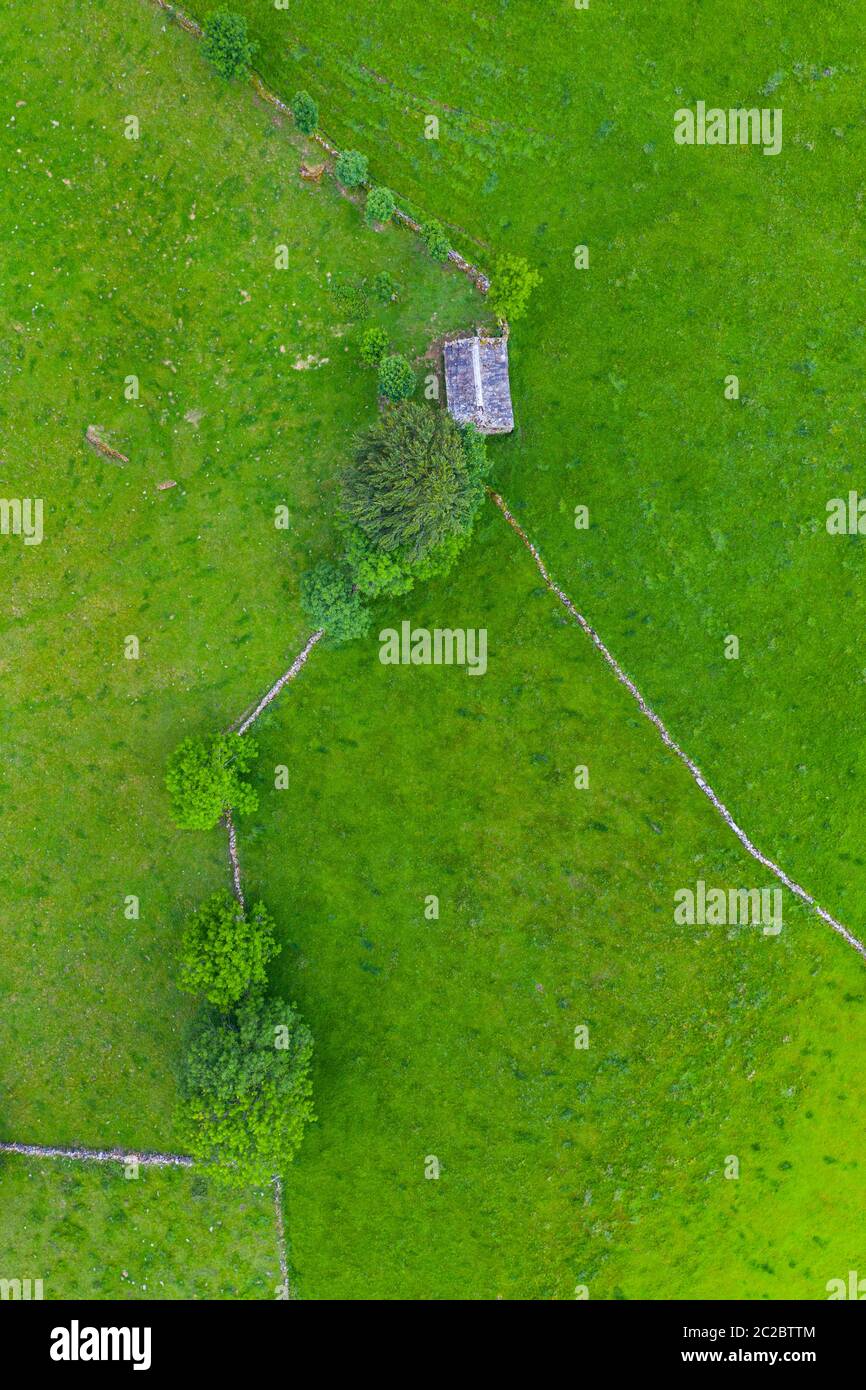 Aerial view with a drone of the spring landscape of pasiegas cabins and meadows in Miera Valley in Autonomous Community of Cantabria. Spain, Europe Stock Photo