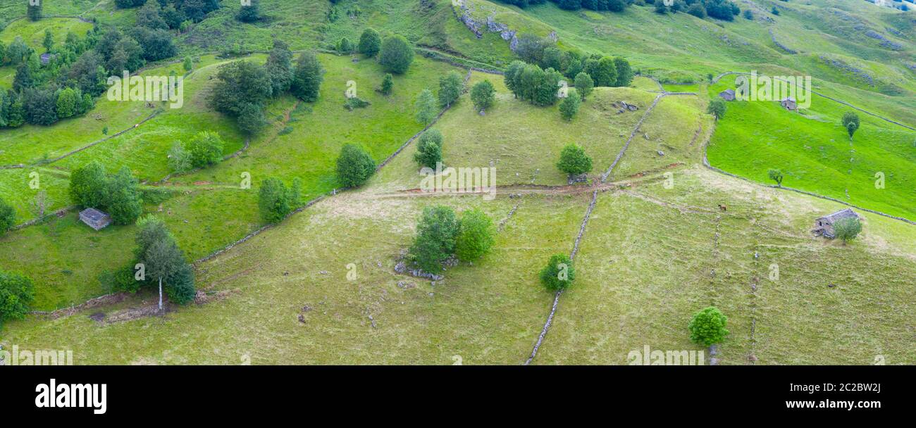Aerial view with a drone of the spring landscape of pasiegas cabins and meadows in Miera Valley in Autonomous Community of Cantabria. Spain, Europe Stock Photo