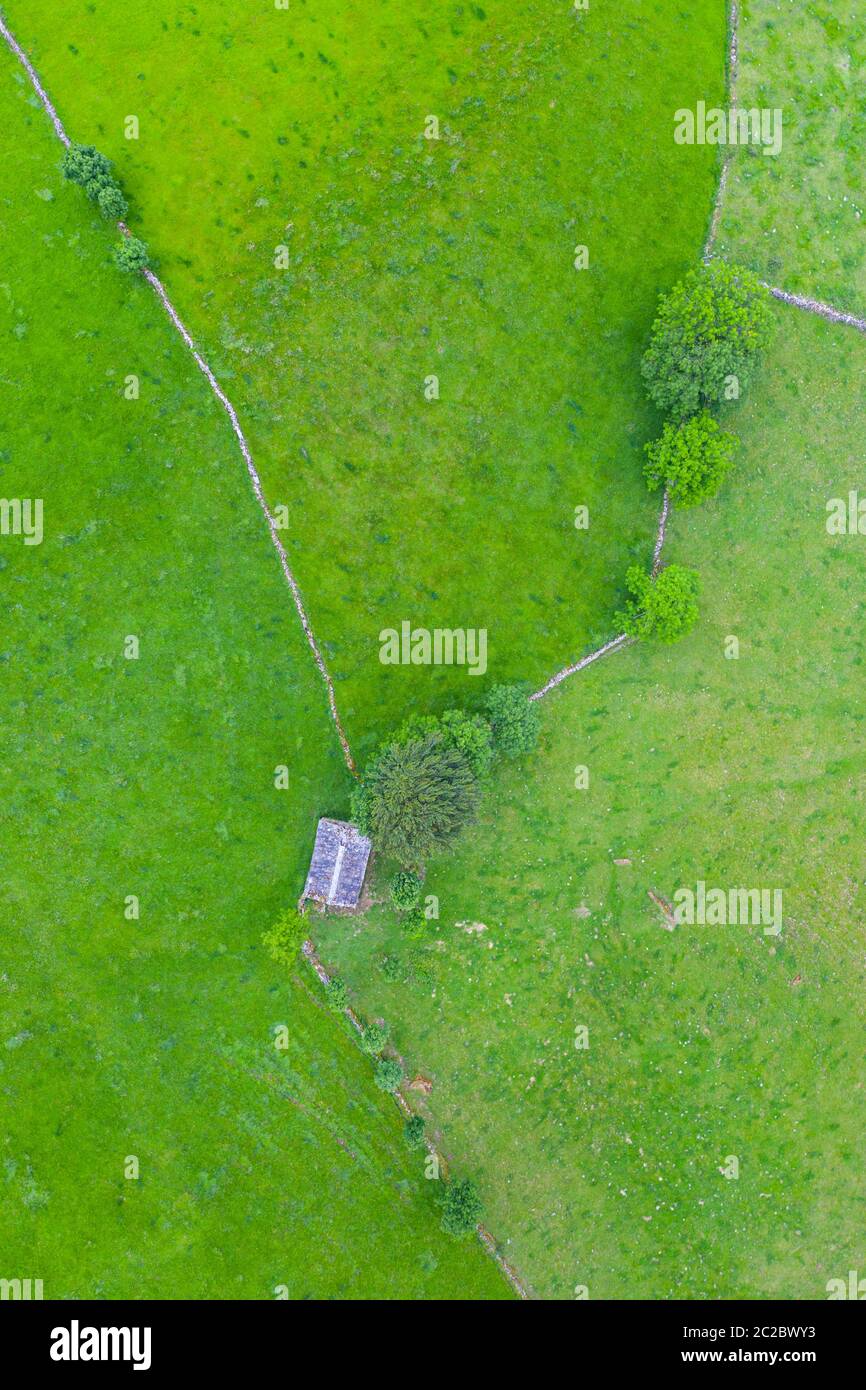 Aerial view with a drone of the spring landscape of pasiegas cabins and meadows in Miera Valley in Autonomous Community of Cantabria. Spain, Europe Stock Photo