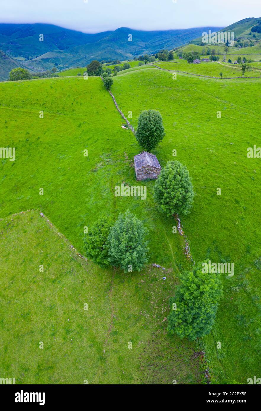 Aerial view with a drone of the spring landscape of pasiegas cabins and meadows in Miera Valley in Autonomous Community of Cantabria. Spain, Europe Stock Photo