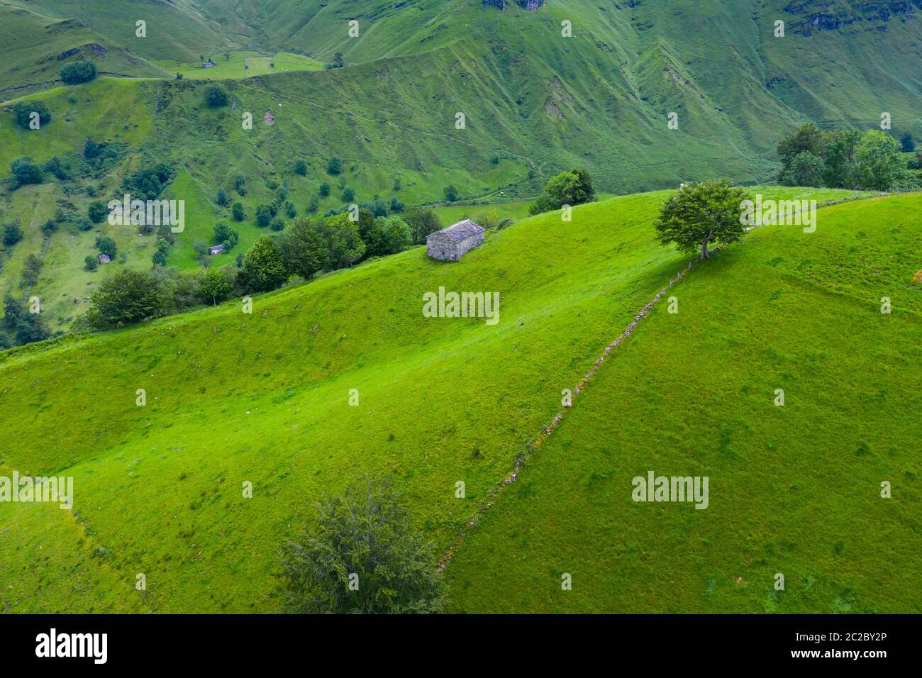 Aerial view with a drone of the spring landscape of pasiegas cabins and meadows in Miera Valley in Autonomous Community of Cantabria. Spain, Europe Stock Photo