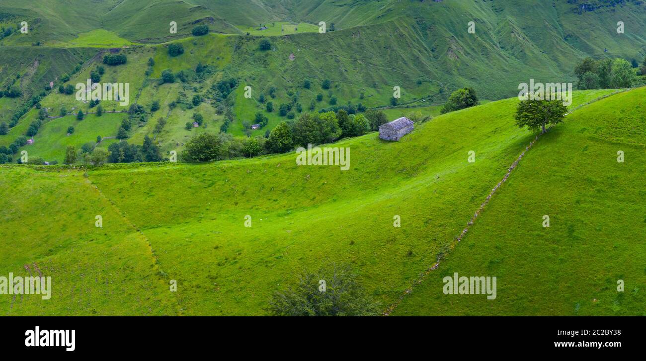Aerial view with a drone of the spring landscape of pasiegas cabins and meadows in Miera Valley in Autonomous Community of Cantabria. Spain, Europe Stock Photo