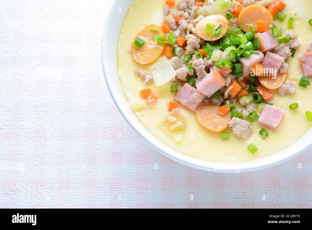 Steamed egg custard cuisine in a white bowl with minced pork, sausage and bacon.  Or Only with egg, Stock Photo