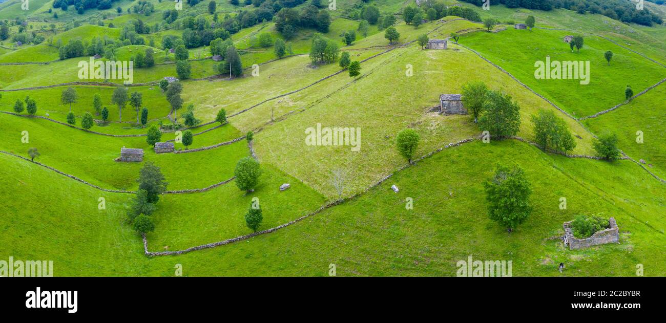 Aerial view with a drone of the spring landscape of pasiegas cabins and meadows in Miera Valley in Autonomous Community of Cantabria. Spain, Europe Stock Photo