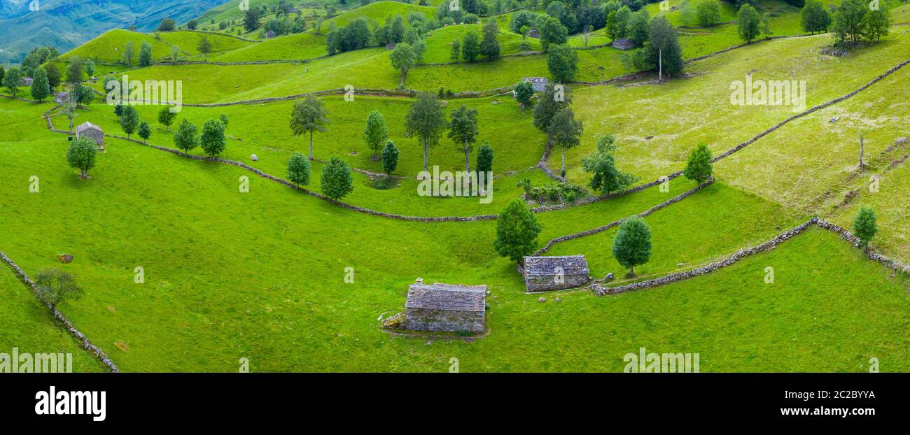 Aerial view with a drone of the spring landscape of pasiegas cabins and meadows in Miera Valley in Autonomous Community of Cantabria. Spain, Europe Stock Photo