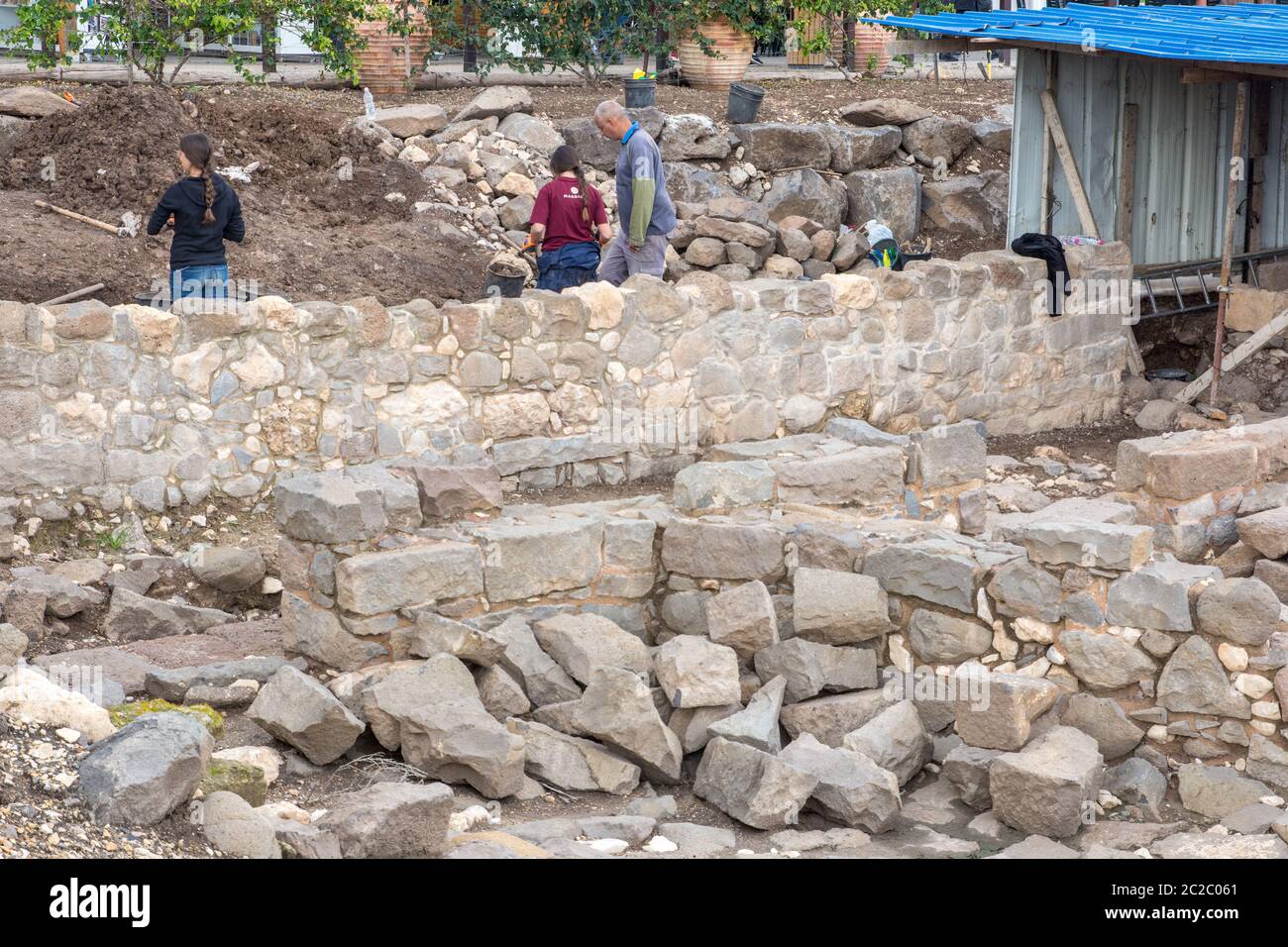 A team of archaeologists aided by a group of young volunteers is excavating an ancient site and ruins. Photographed at Magdala (Mejdel) - current day Stock Photo