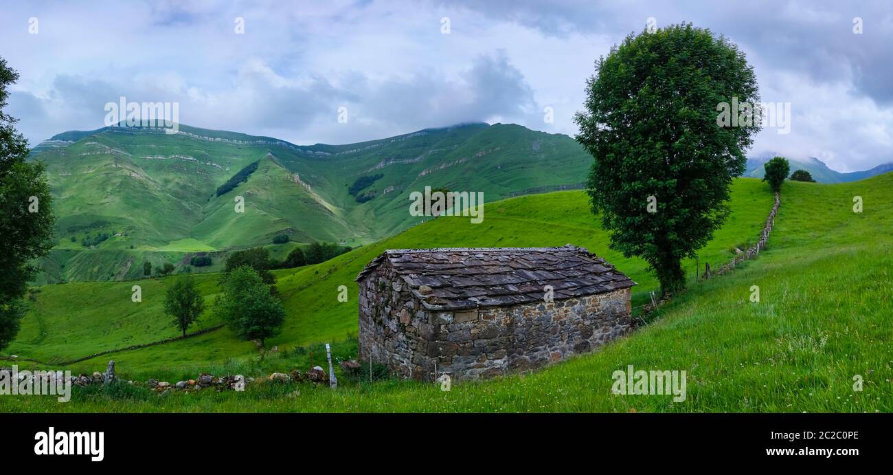 Spring landscape of pasiegas cabins and meadows in the Miera Valley in the Autonomous Community of Cantabria. Spain, Europe Stock Photo
