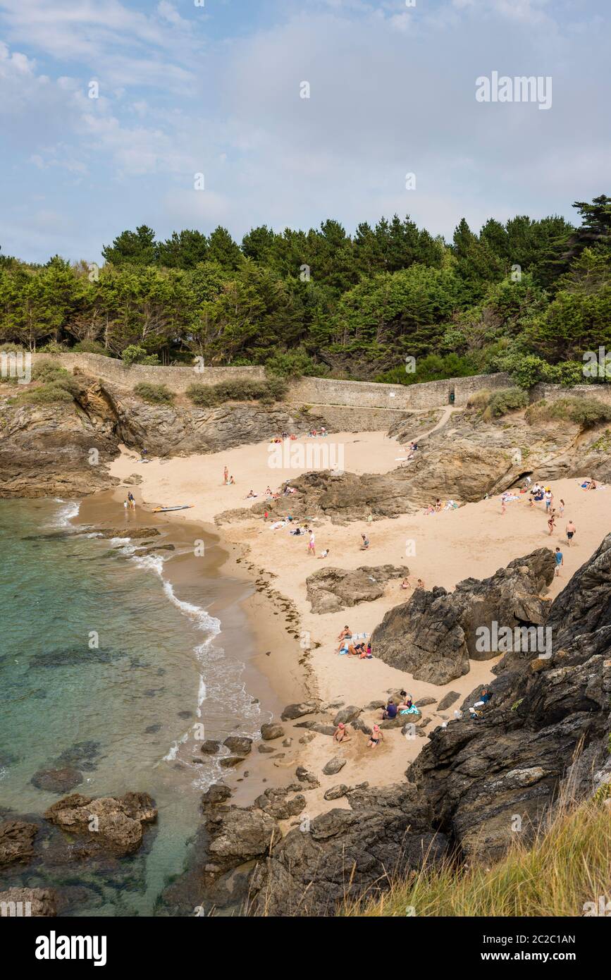 People on sandy beach at small cove, St Ennogat, Dinard, Brittany, France Stock Photo