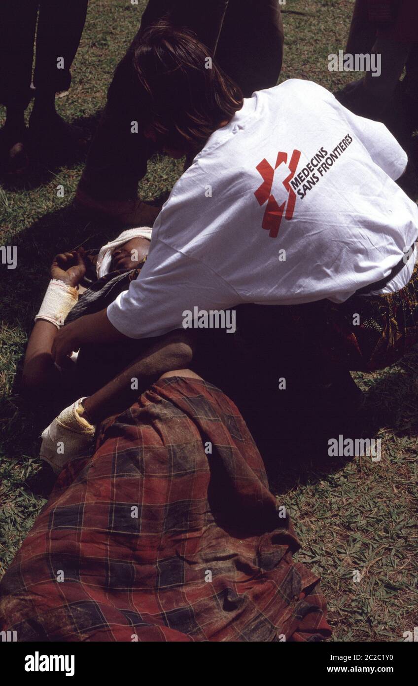 MSF nurse tends to Rwandan Tutsi woman lying injured in Burundi 1994 ...