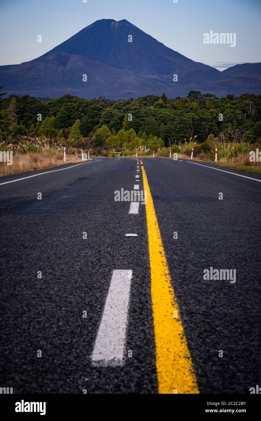 Low perspective shot of a road in  Tongariro national park on New Zealand's north island, with Mount Ngauruhoe, also used at Mt Doom in the Lord of th Stock Photo