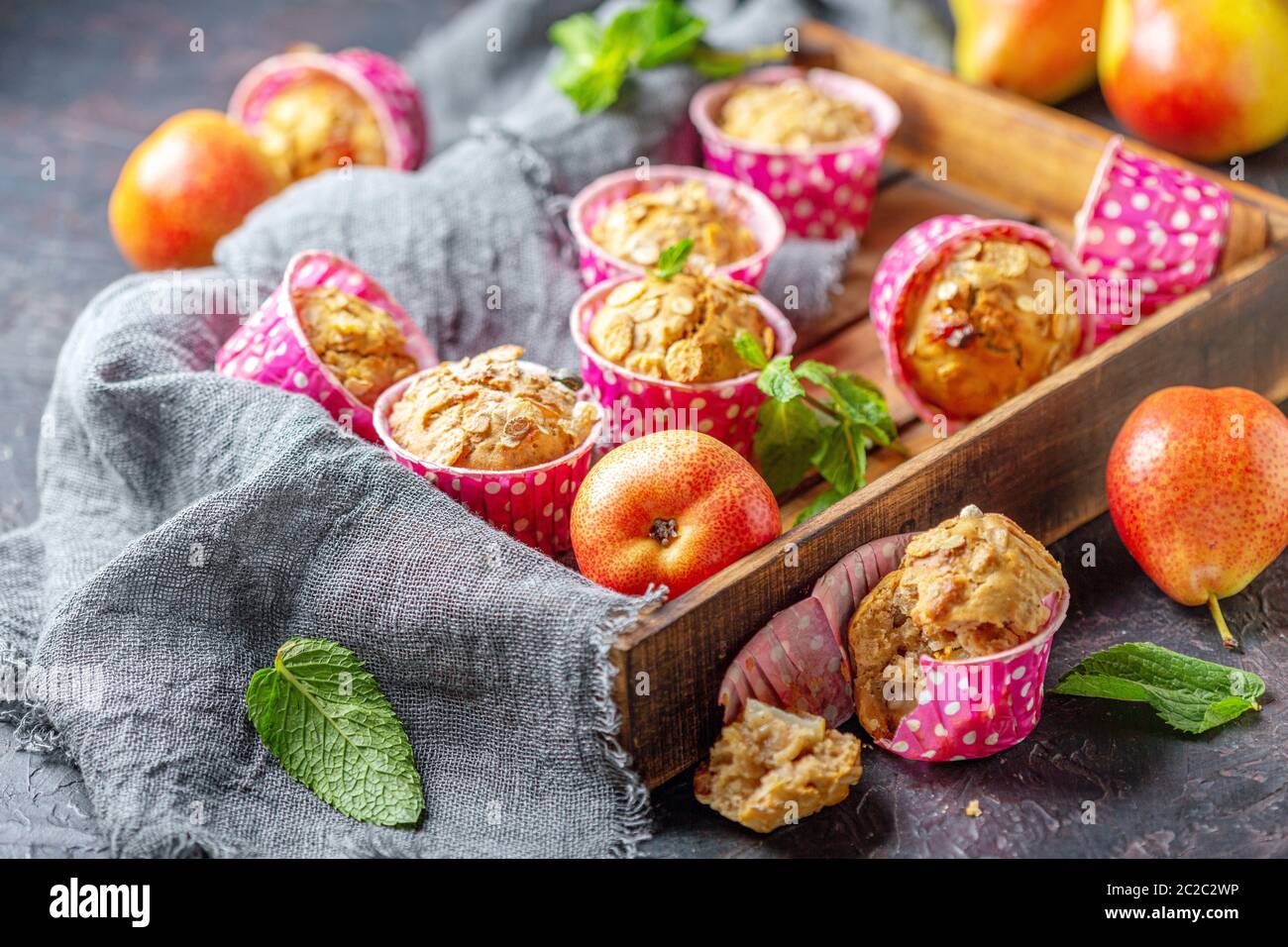 Muffins with pears and muesli in a wooden tray. Stock Photo
