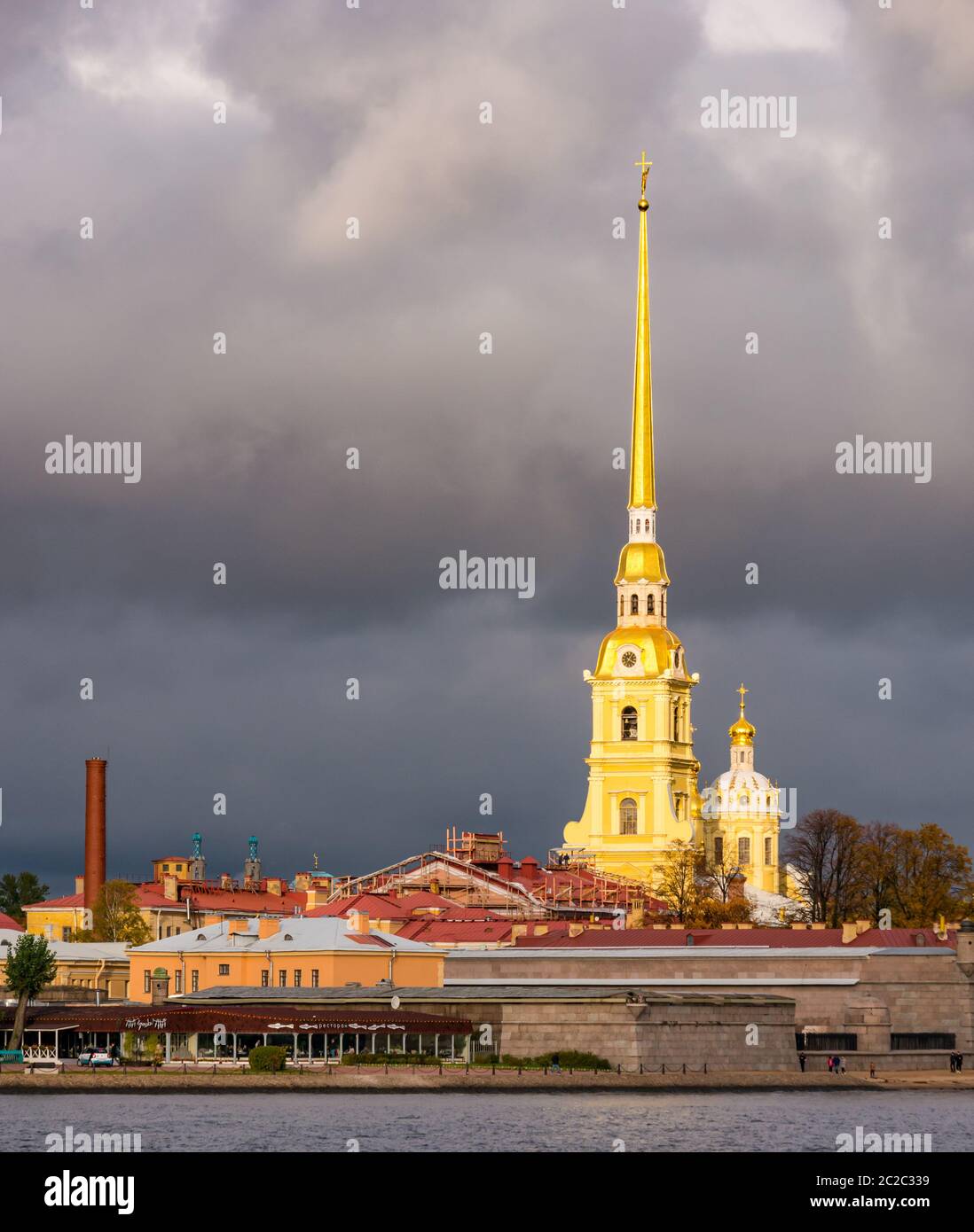 Peter and Paul Cathedral spire, Peter and Paul Fortress on Neva River with moody stormy sky, St Petersburg, Russia Stock Photo