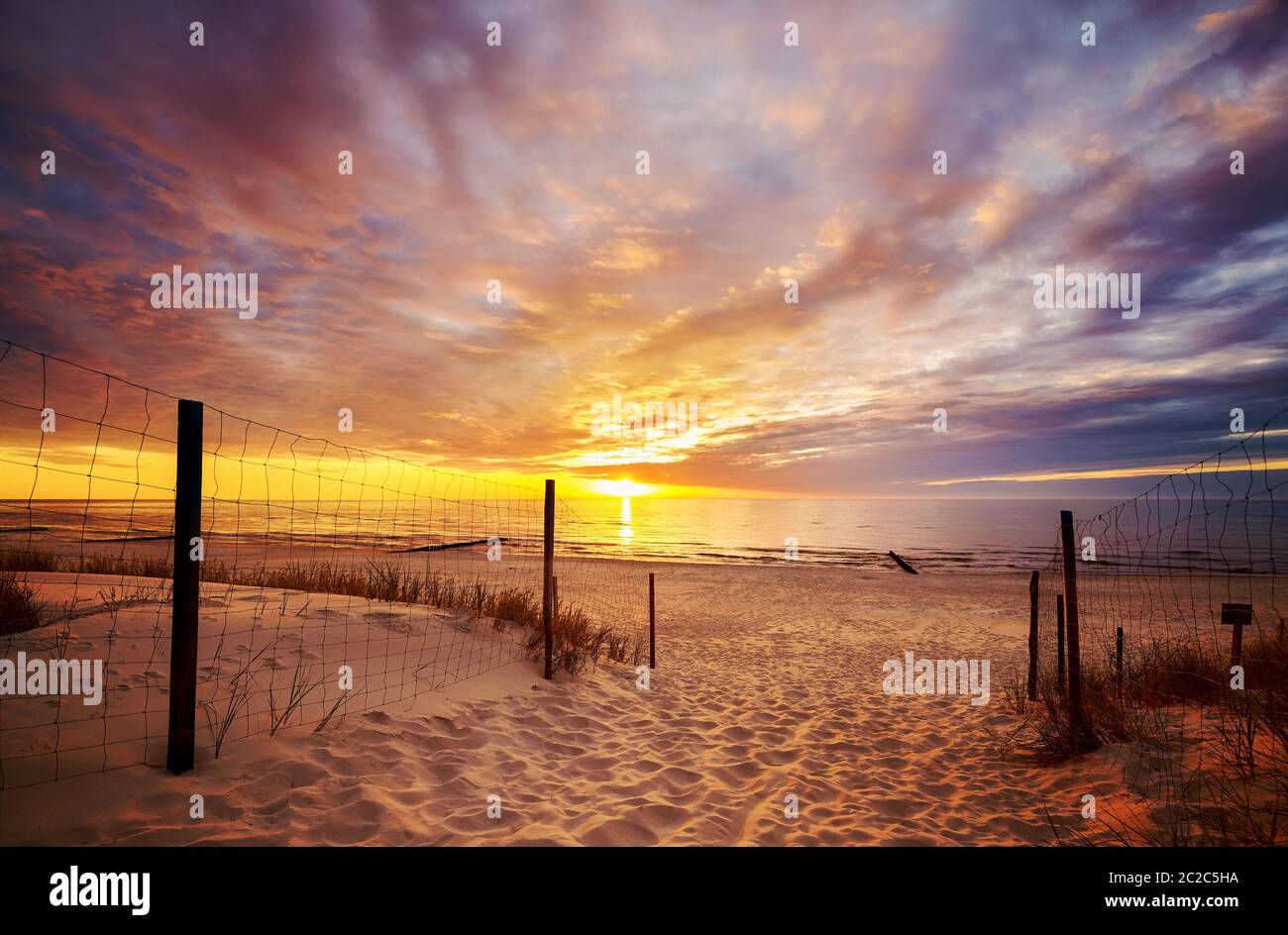 Scenic sunset over Baltic Sea beach with dramatic cloudscape, Poland. Stock Photo