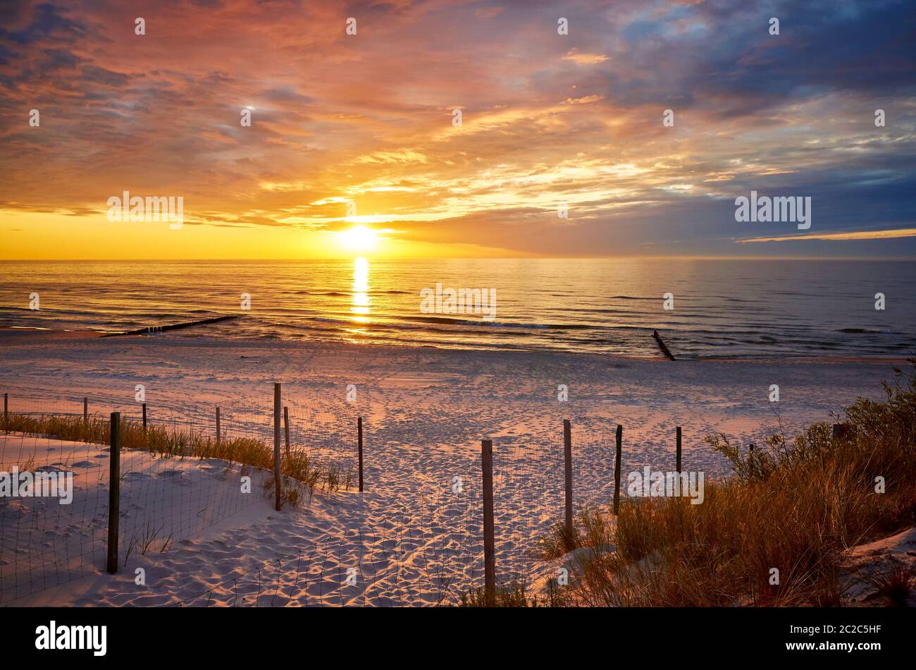 Beach entrance at a beautiful purple sunset Stock Photo Alamy