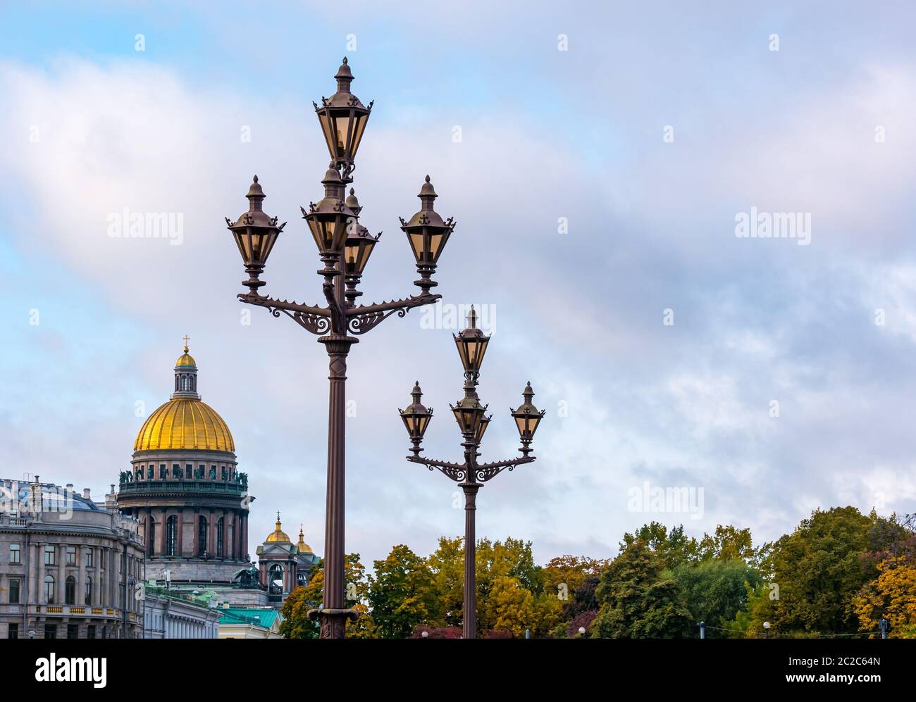 St Isaac's Cathedral dome in Autumn and ornate old fashioned streetlights, St Petersburg, Russia Stock Photo