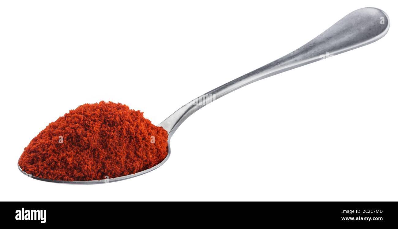 Pile of red paprika powder in spoon isolated on white background with clipping path, ground red