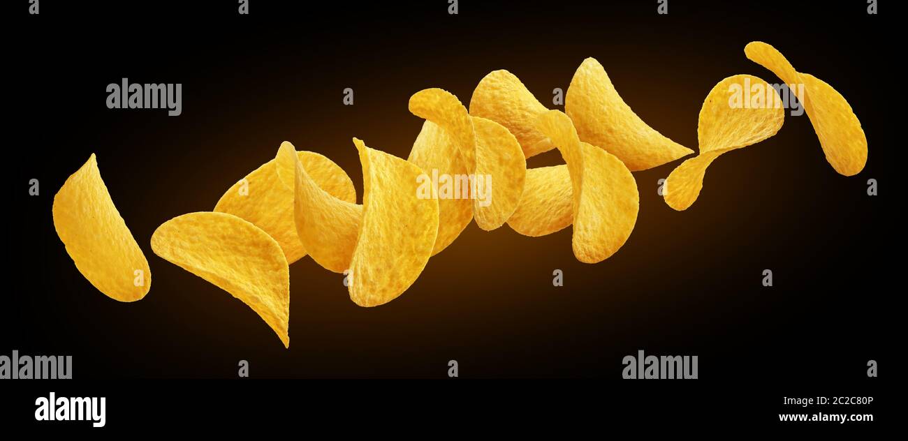 Falling potato chips isolated on black background Stock Photo