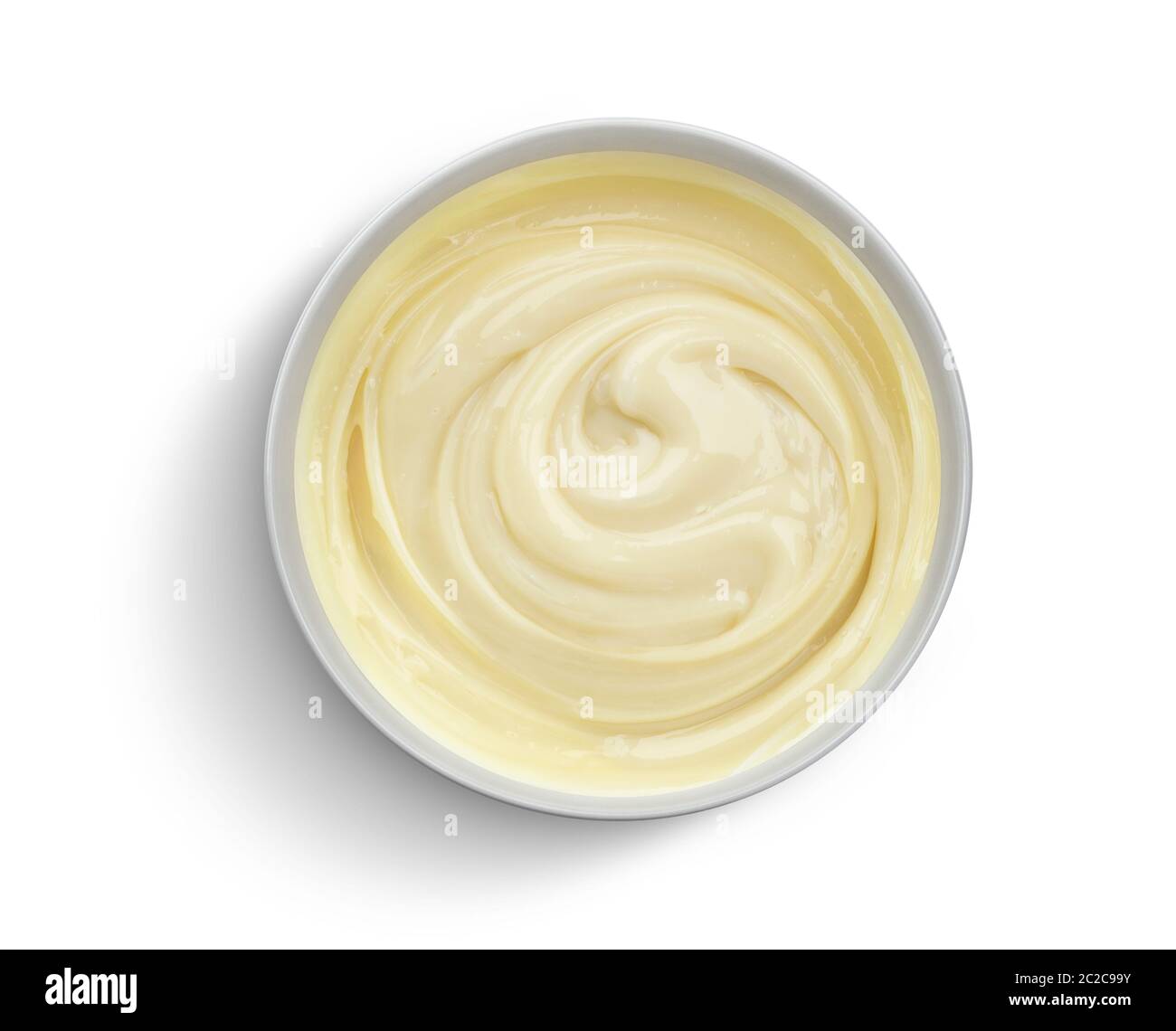 Bowl of condensed milk cream isolated on white background, top view Stock Photo