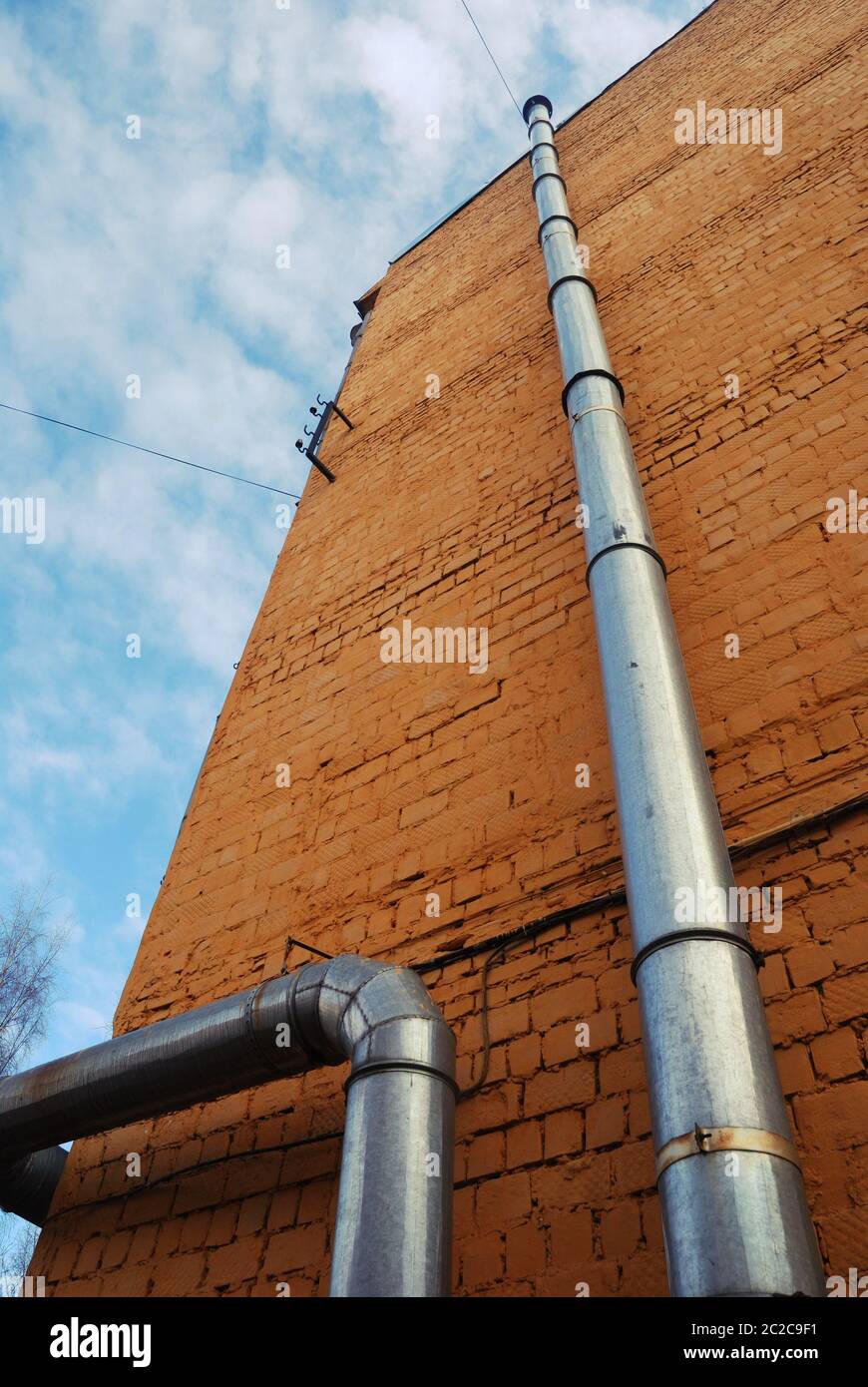 two ventilation pipes on a brick wall Stock Photo