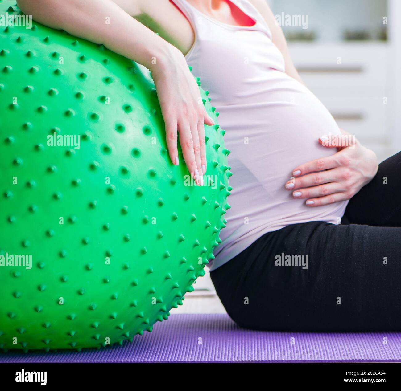 Pregnant woman exercising in anticipation of child birth Stock Photo