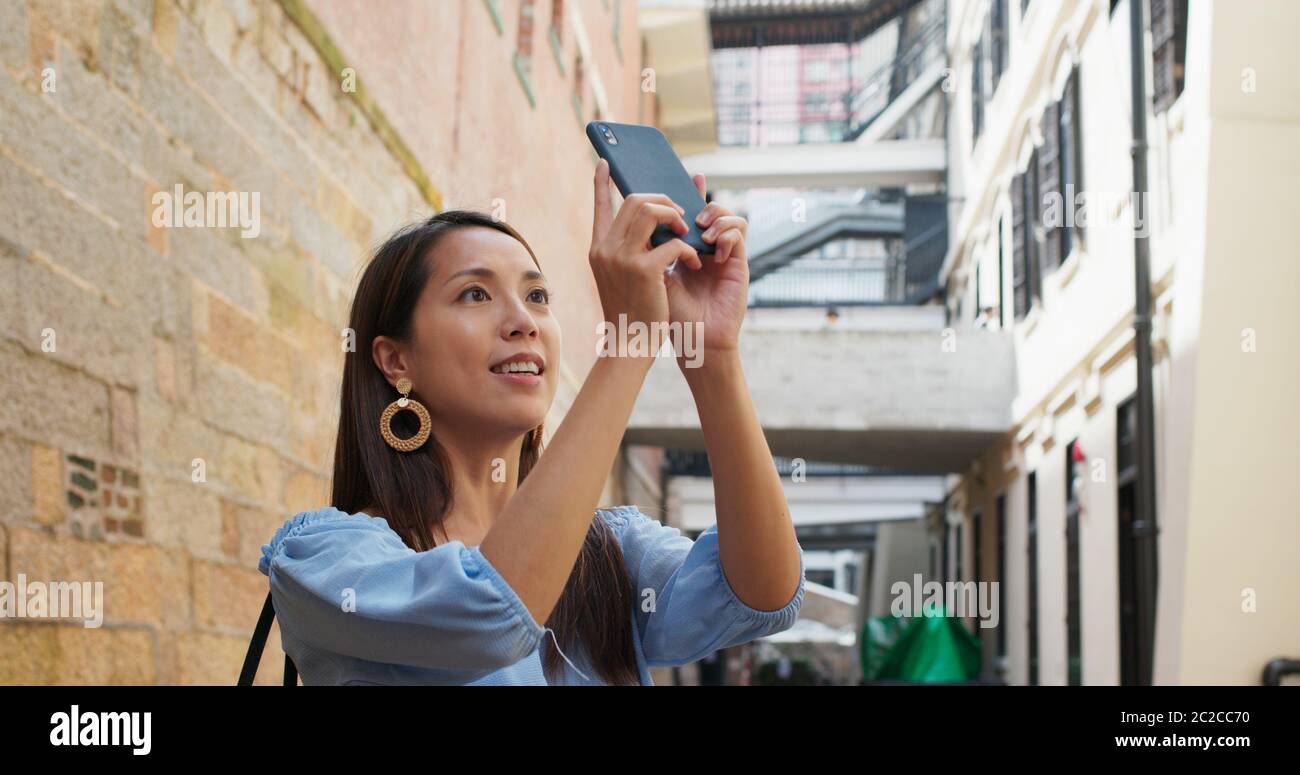 Woman tourist visit Hong Kong city and take photo on cellphone Stock ...