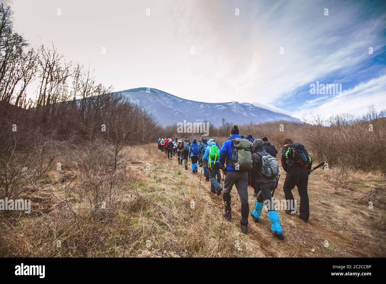 Hiking, Travel, Adventure. Explore. Large group of active people walking on a mountain landscape in autumn day. Stock Photo