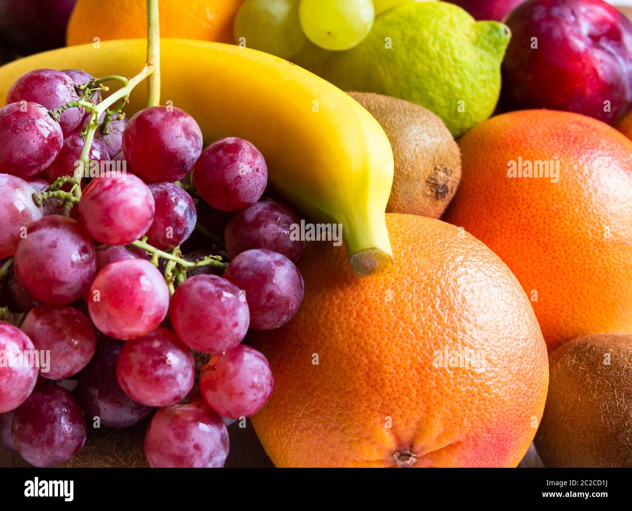Fresh whole and cut fruit, orange, banana, grapes and other fruits Stock Photo Alamy