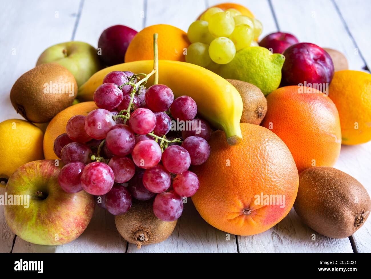 Fresh whole and cut fruit, orange, banana, grapes and other fruits Stock Photo Alamy