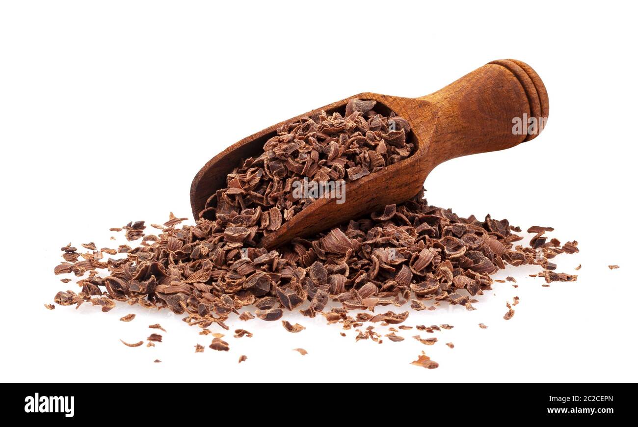 Grated chocolate. Pile of ground chocolate with wooden scoop isolated