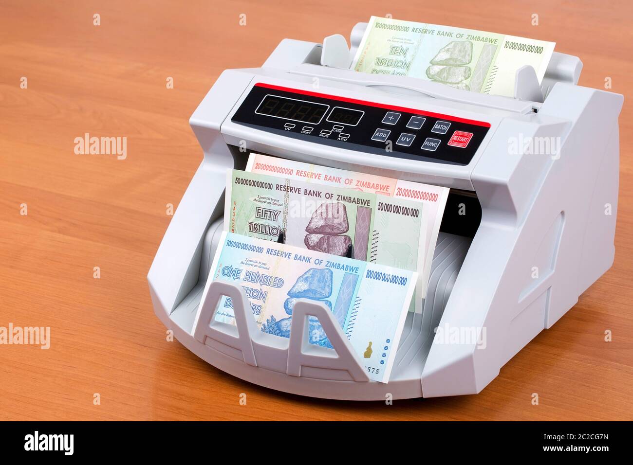 Trillion dollars from Zimbabwe in a counting machine Stock Photo
