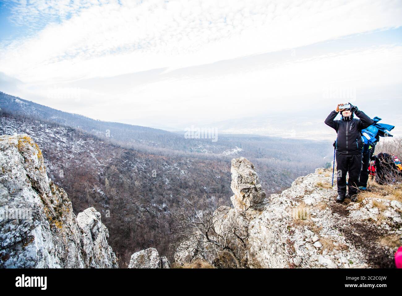 Hiker taking a photo of nature landscape with phone. Stock Photo