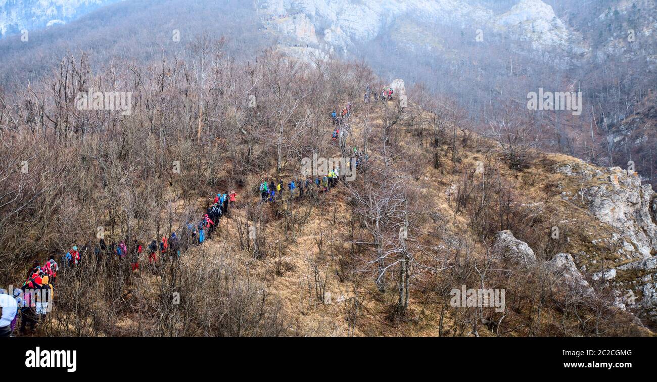 Large Group Of Hikers reaches the top of the mountain peak Stock Photo ...