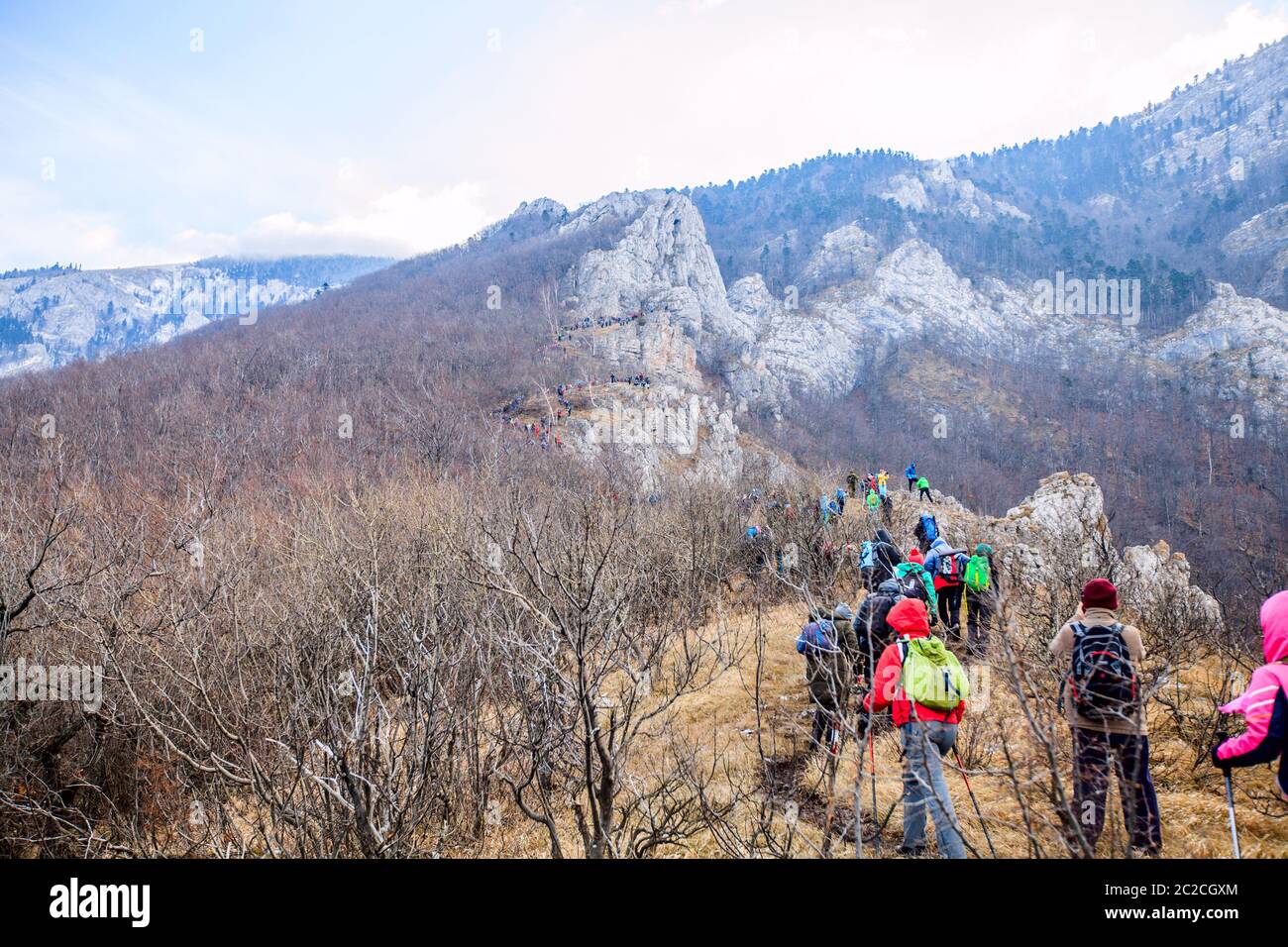 Group Of Mountaineers reaches the top of the mountain peak Stock Photo