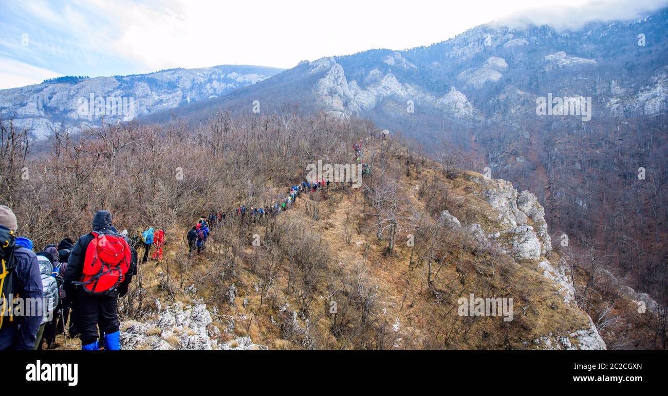 Large Group Of Hikers reaches the top of the mountain peak Stock Photo ...