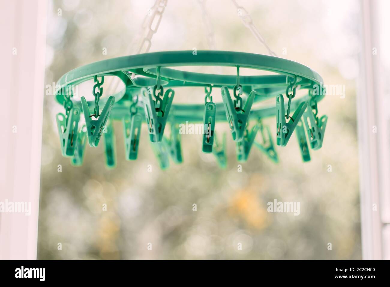 Colored clothespins on a rope on a blurred background Stock Photo