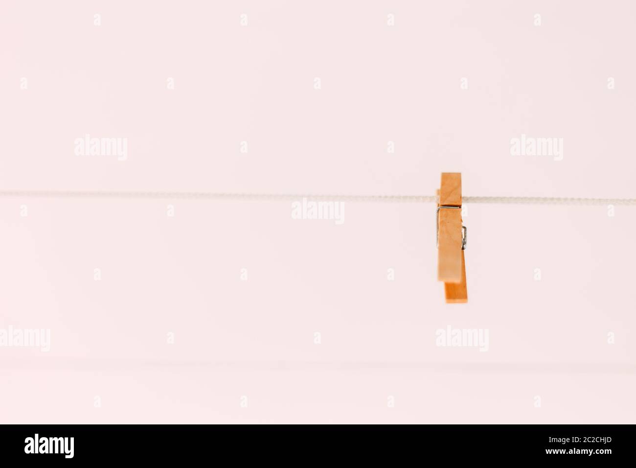 Colored clothespins on a rope on a blurred background Stock Photo
