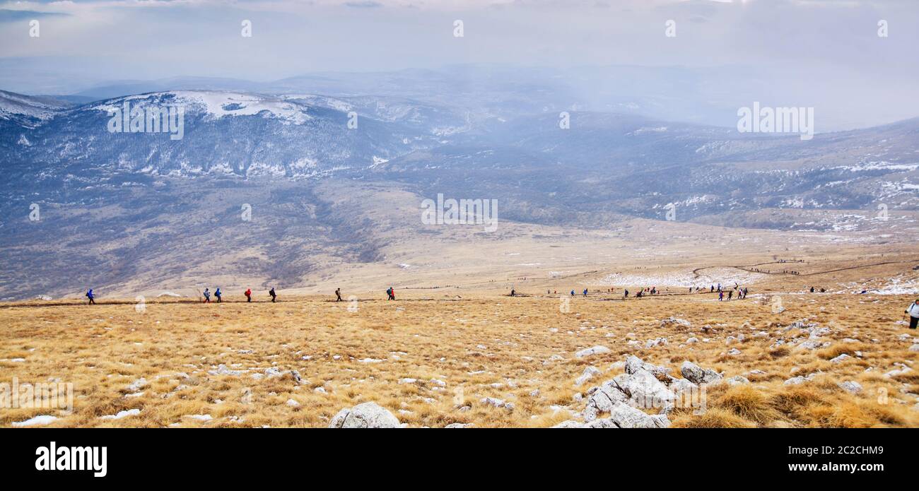 Amazing Winter Mountain Landscape. Group Of Mountaineers Descends Down Mountain Trail Stock Photo