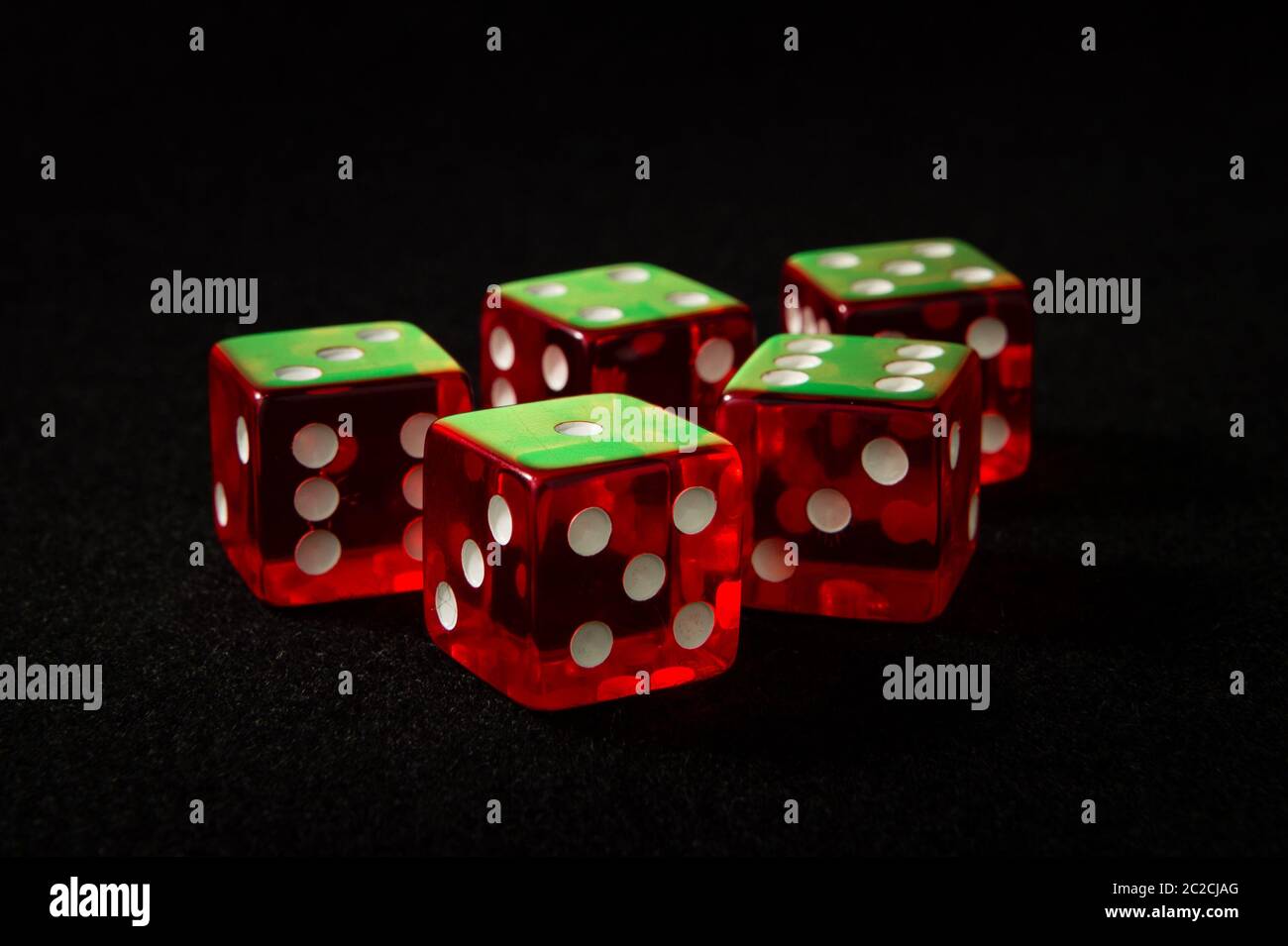 red dice on a black felt Stock Photo