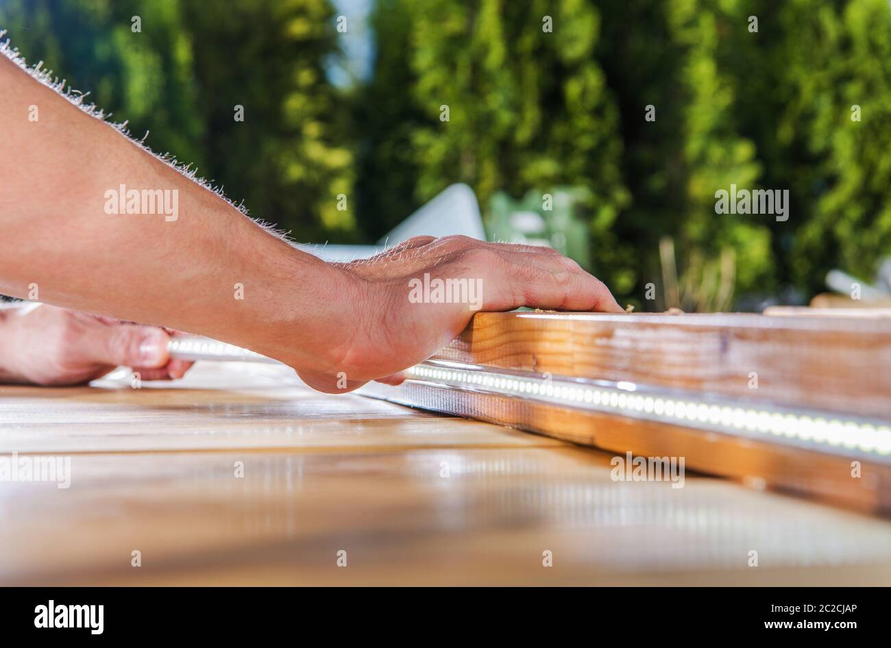 Modern LED Lighting Installation Inside Wooden Garden Elements. Modern Carpentry Theme. Light-Emitting Diode Close Up. Detailed Photo. Stock Photo